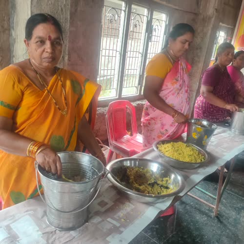 Two women serving curry and rice from vessels