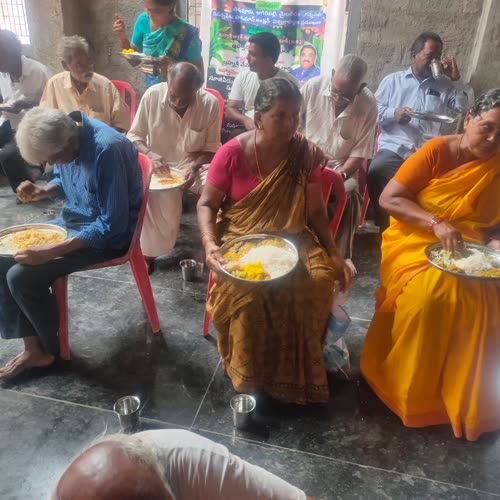 Rows of devotees eating together