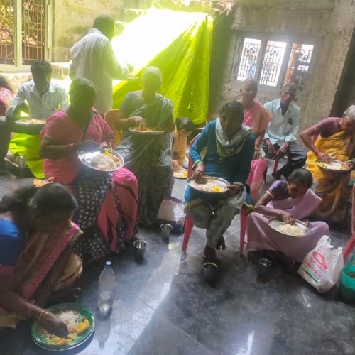 Families seated on the floor, eating together